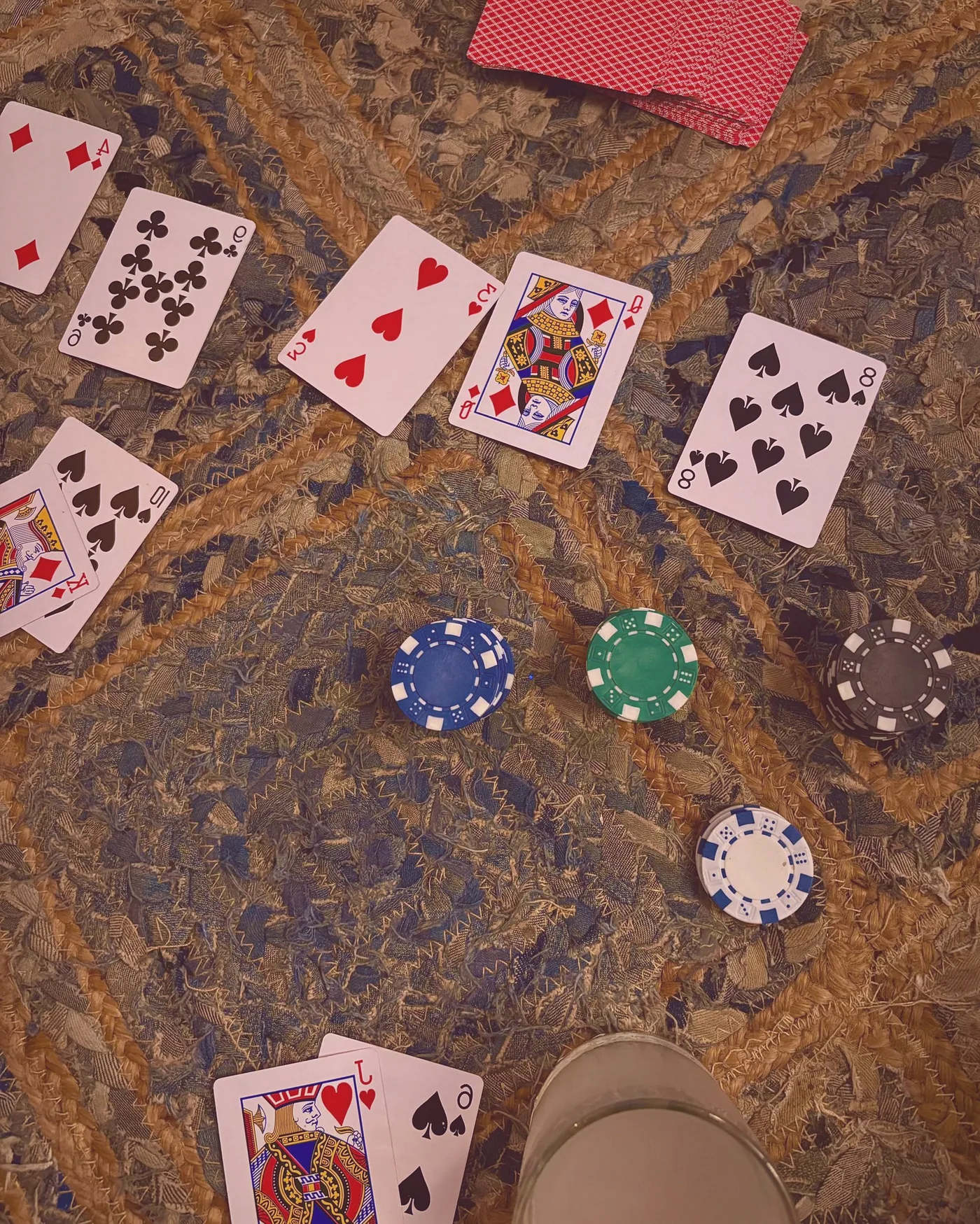 Cards mid-deal at the euchre table