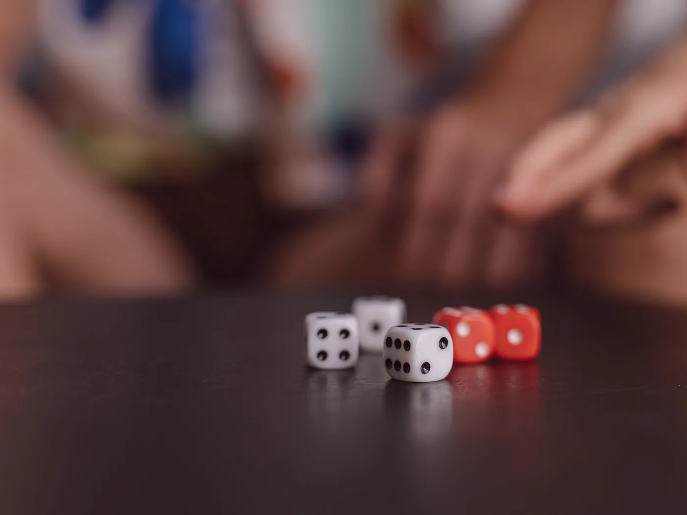 Hand of cards being dealt across felt